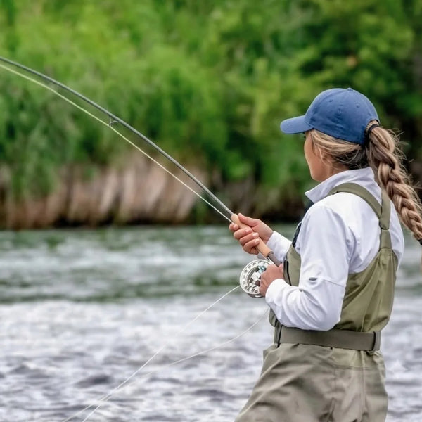 Female fly fisher casting on the river — Axon fly rod collection, lightweight high-performance carbon

